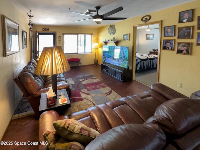 living area with a ceiling fan and wood finished floors