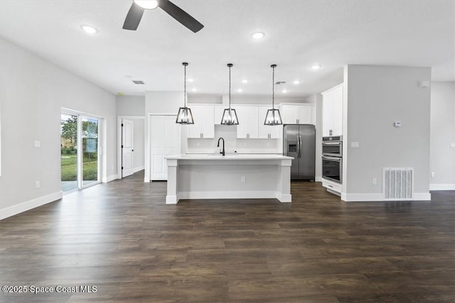 kitchen with a sink, visible vents, ceiling fan, light countertops, and appliances with stainless steel finishes