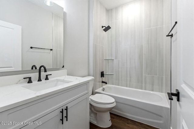 full bath with wood finished floors, bathing tub / shower combination, vanity, and toilet