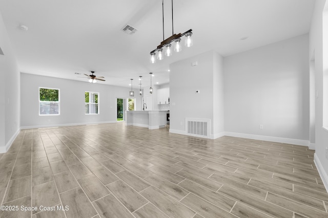 8276 100th Ave, Vero Beach, FL 32967 - unfurnished living room featuring ceiling fan and light wood finished floors