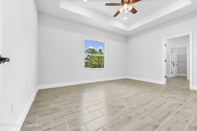 8276 100th Ave, Vero Beach, FL 32967 - empty room with a tray ceiling, ceiling fan, wood finish floors, and recessed lighting