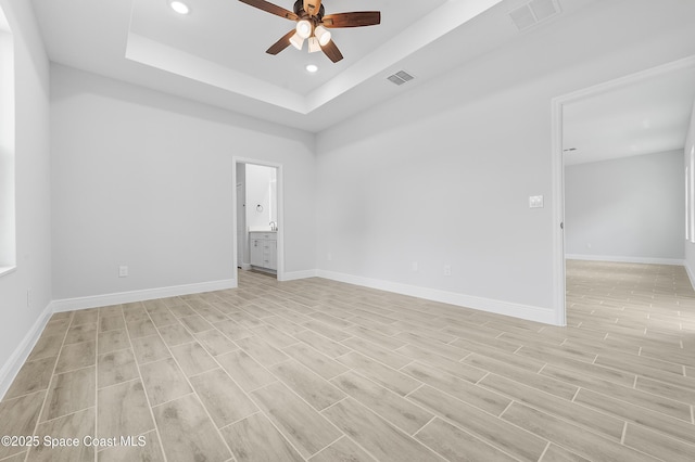 8276 100th Ave, Vero Beach, FL 32967 - unfurnished room with a ceiling fan, a tray ceiling, recessed lighting, and light wood-style floors