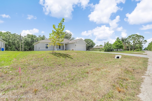 8276 100th Ave, Vero Beach, FL 32967 - view of green lawn with a garage