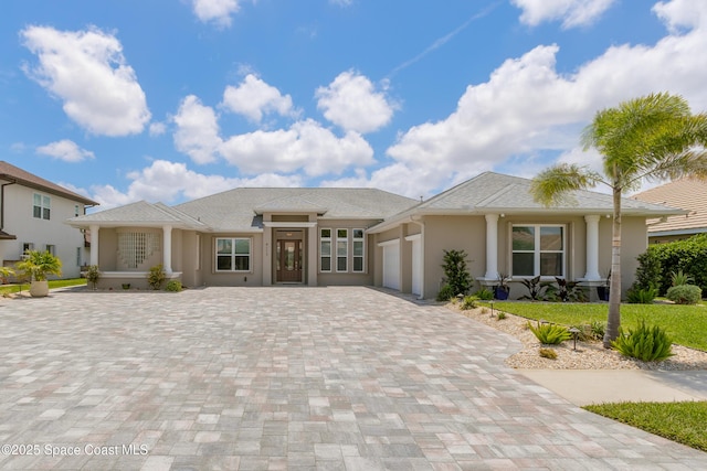 4117 Melrose Ct, Melbourne, FL 32940 - prairie-style home with decorative driveway, a garage, and stucco siding