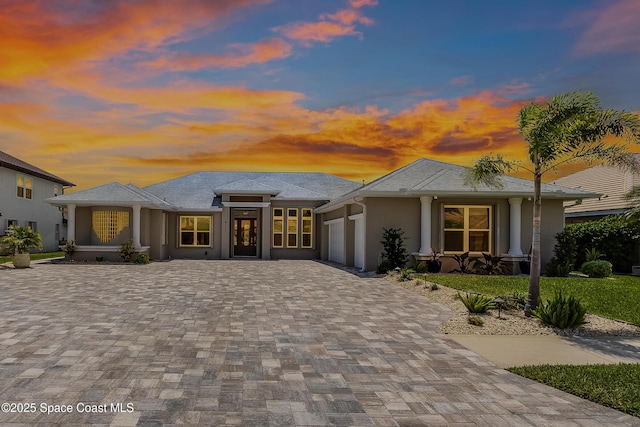 4117 Melrose Ct, Melbourne, FL 32940 - prairie-style house with a garage, stucco siding, and decorative driveway