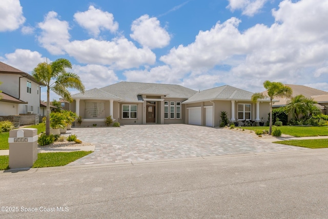 4117 Melrose Ct, Melbourne, FL 32940 - ranch-style home with a garage, stucco siding, and decorative driveway