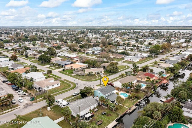 bird's eye view featuring a residential view and a water view