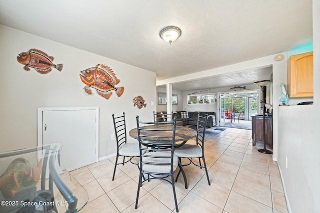 dining room with baseboards and light tile patterned flooring
