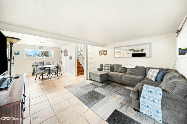 living area with stairway and light tile patterned floors