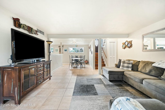 living area featuring visible vents, stairs, and light tile patterned floors