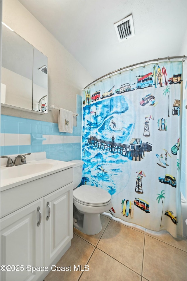 bathroom featuring vanity, toilet, tile patterned flooring, a shower with shower curtain, and visible vents