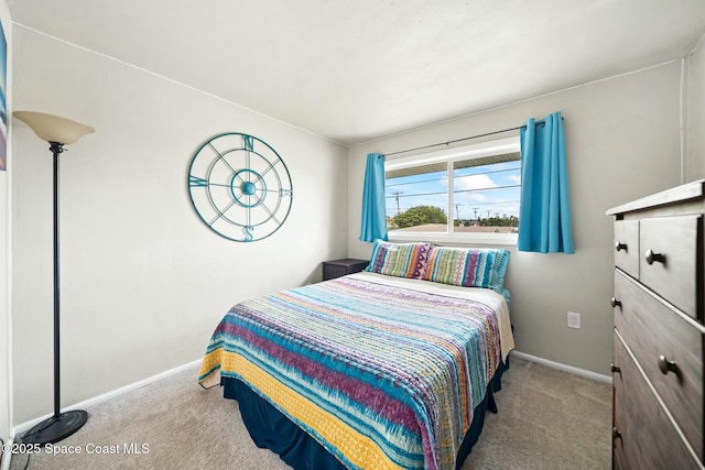 carpeted bedroom featuring baseboards