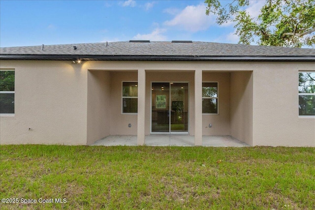 958 Chace Ln NE, Palm Bay, FL 32905 - rear view of property featuring a patio, stucco siding, a yard, and a shingled roof