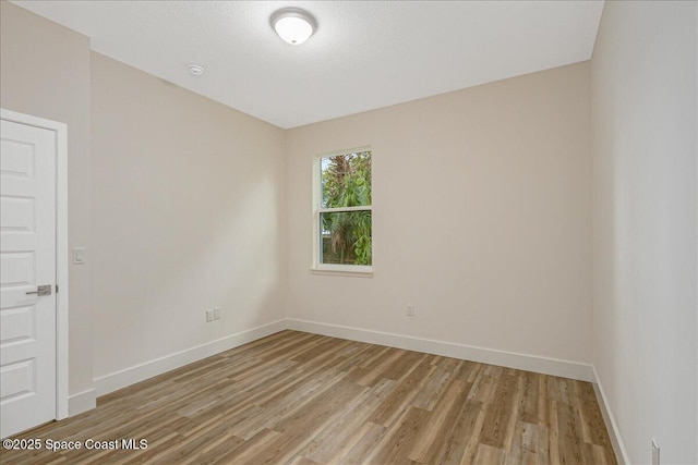 958 Chace Ln NE, Palm Bay, FL 32905 - empty room featuring light wood-style floors and a smoke detector