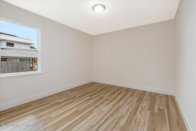 958 Chace Ln NE, Palm Bay, FL 32905 - spare room featuring light wood-type flooring and a smoke detector
