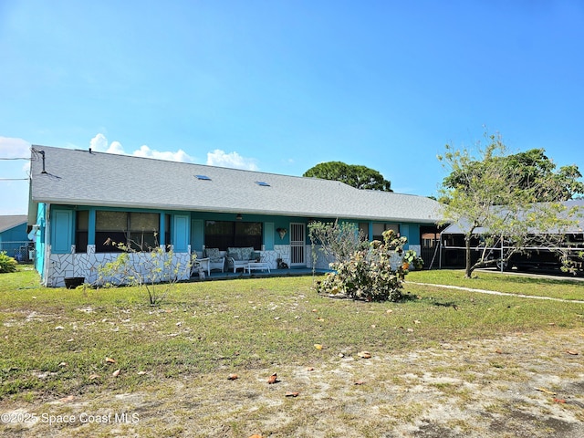 ranch-style home featuring a front lawn and roof with shingles