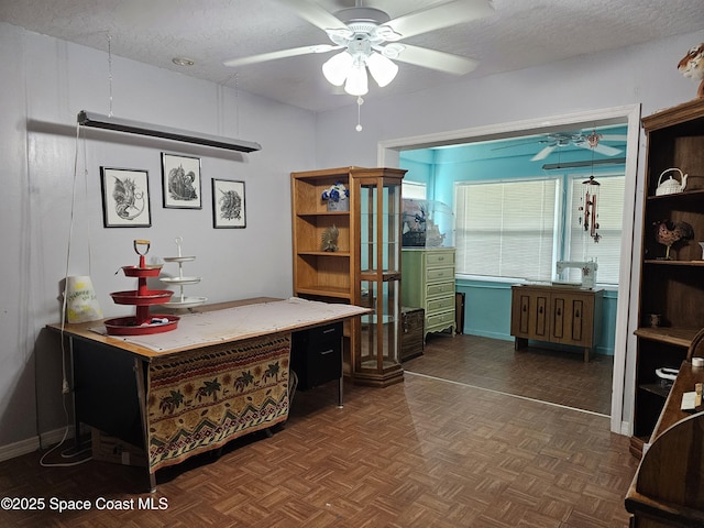 office with a ceiling fan and a textured ceiling