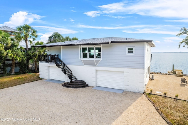 860 S Banana River Dr, Merritt Island, FL 32952 - ranch-style home with stairway, brick siding, and a water view