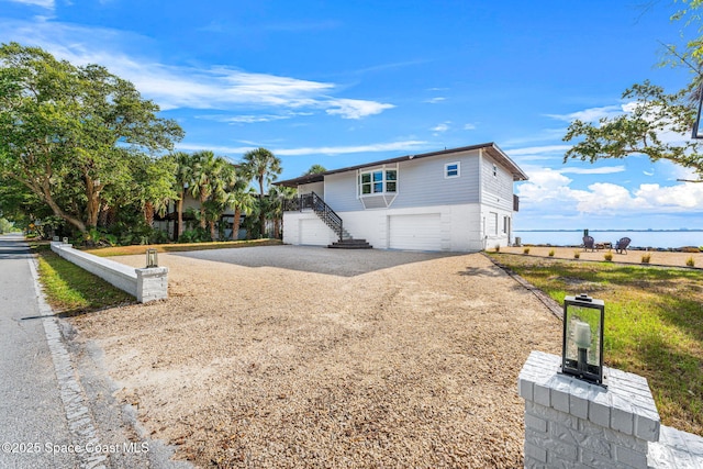 860 S Banana River Dr, Merritt Island, FL 32952 - exterior space with a garage, dirt driveway, and stairway