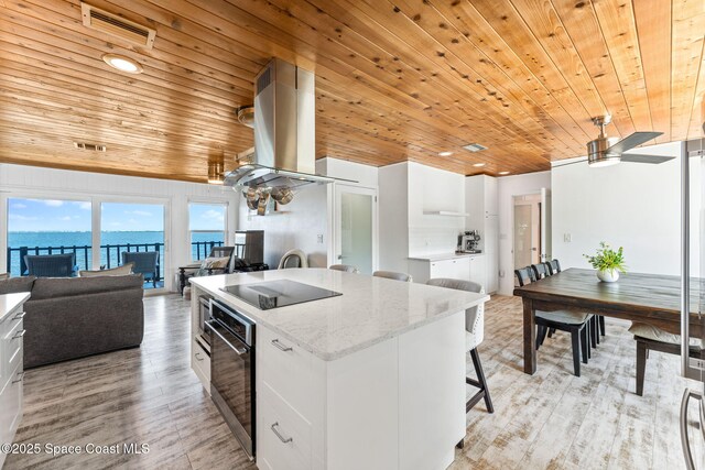 860 S Banana River Dr, Merritt Island, FL 32952 - kitchen with wood ceiling, exhaust hood, wall oven, black electric cooktop, and open floor plan