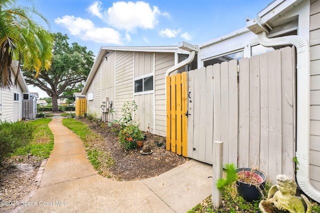 view of property exterior with a gate and fence