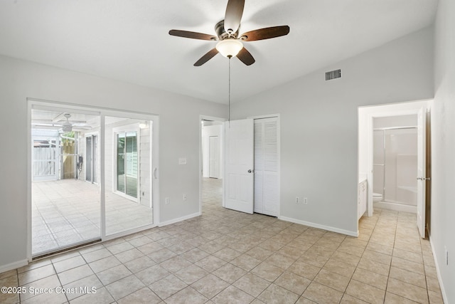 unfurnished bedroom featuring visible vents, connected bathroom, access to outside, lofted ceiling, and light tile patterned flooring