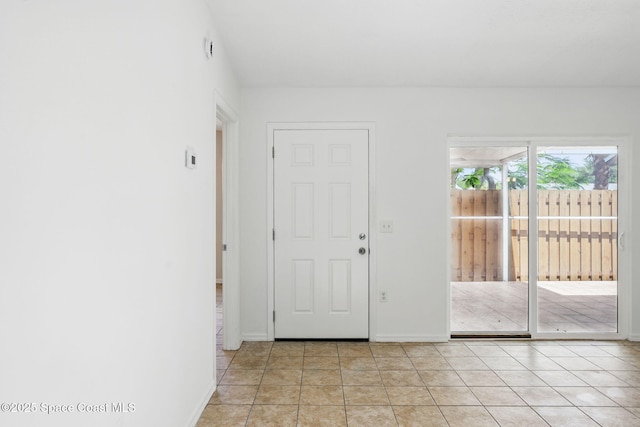interior space featuring baseboards and light tile patterned floors