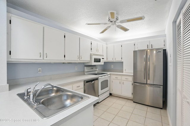 kitchen featuring a sink, light countertops, stainless steel appliances, and a textured ceiling