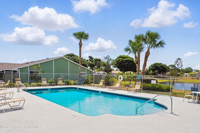 community pool featuring fence and a patio area