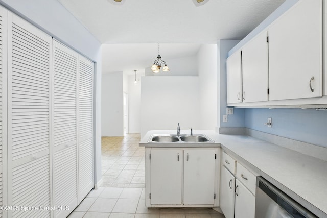 kitchen with a sink, light countertops, a chandelier, white cabinetry, and stainless steel dishwasher