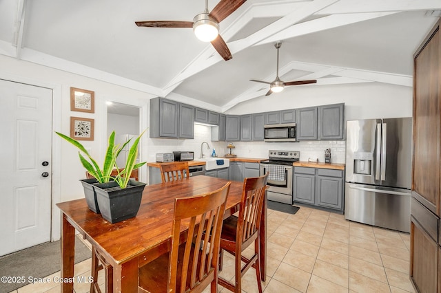 6010 Flamingo Ave, Cocoa, FL 32927 - kitchen featuring ceiling fan, beam ceiling, stainless steel appliances, and gray cabinetry