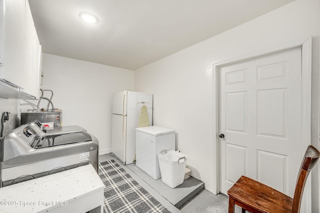 6010 Flamingo Ave, Cocoa, FL 32927 - clothes washing area featuring cabinet space, electric water heater, and separate washer and dryer