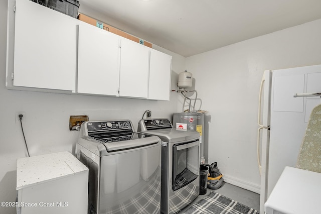 6010 Flamingo Ave, Cocoa, FL 32927 - laundry room with cabinet space, independent washer and dryer, baseboards, and electric water heater