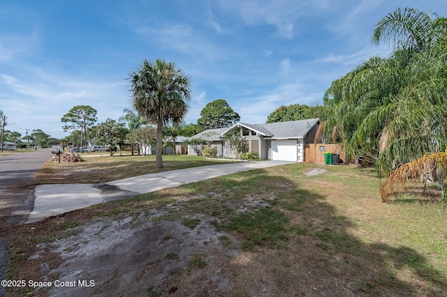 6010 Flamingo Ave, Cocoa, FL 32927 - single story home featuring an attached garage, driveway, a front yard, and fence