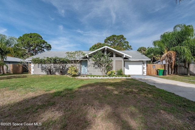 6010 Flamingo Ave, Cocoa, FL 32927 - mid-century home with an attached garage, fence, a front yard, and concrete driveway
