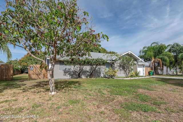 6010 Flamingo Ave, Cocoa, FL 32927 - view of front of house with a garage, a front lawn, and fence