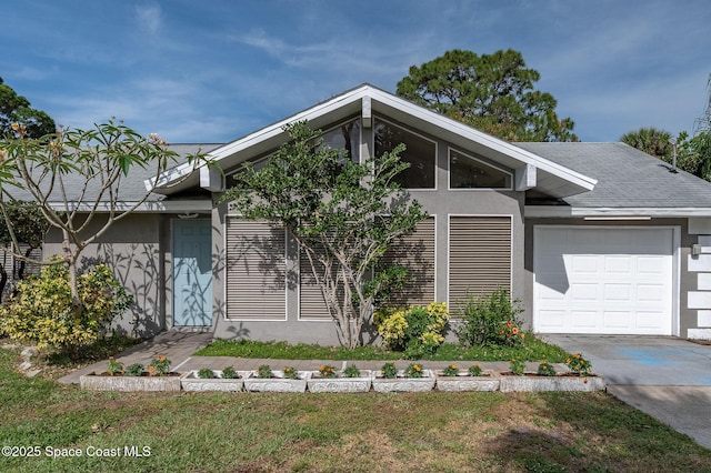 6010 Flamingo Ave, Cocoa, FL 32927 - mid-century inspired home featuring an attached garage, driveway, and stucco siding