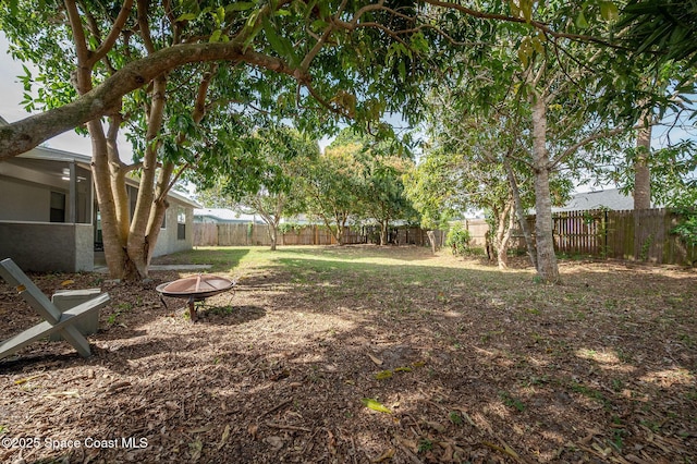6010 Flamingo Ave, Cocoa, FL 32927 - view of yard featuring a fire pit and a fenced backyard