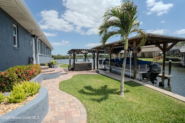 view of yard featuring a water view, central AC unit, boat lift, a hot tub, and a dock
