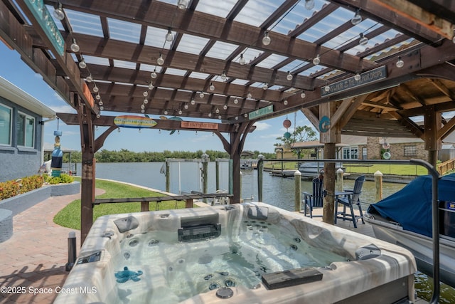 exterior space with a pergola, a hot tub, and a water view