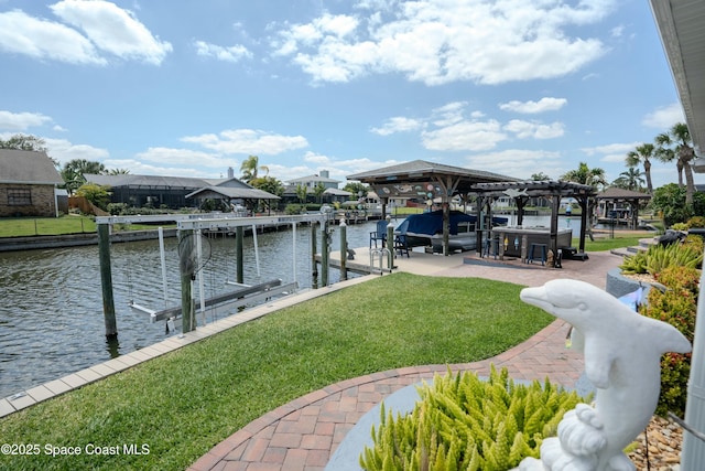 view of dock with a lawn, a water view, and boat lift