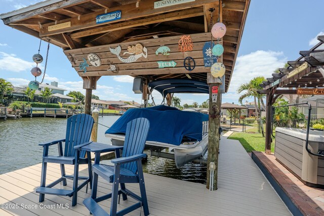 dock area featuring boat lift and a water view