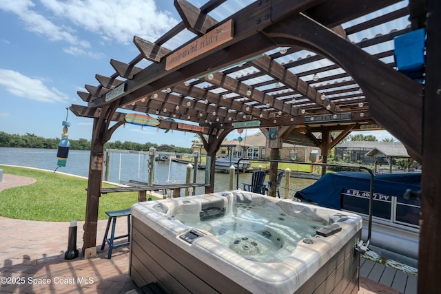 deck featuring a lawn, a hot tub, and a water view
