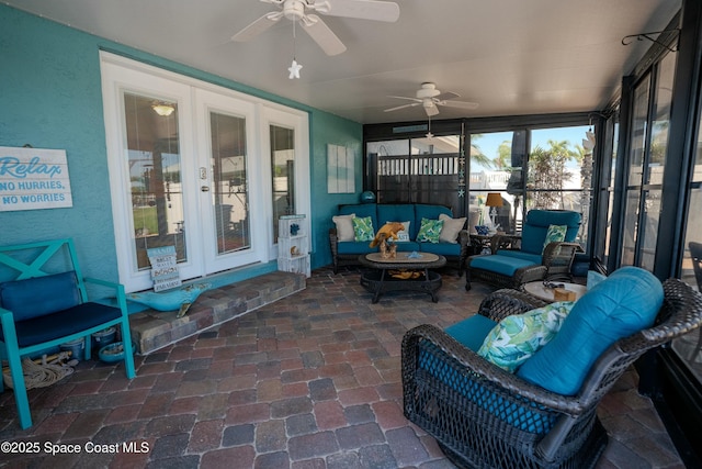 sunroom / solarium with french doors and a ceiling fan