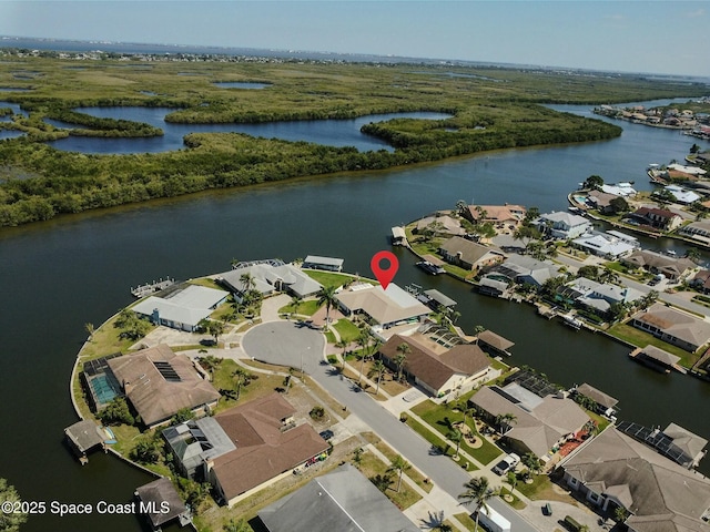 drone / aerial view featuring a residential view and a water view