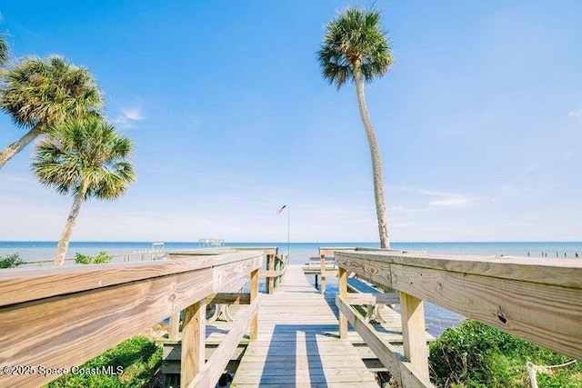 surrounding community featuring a beach view and a water view