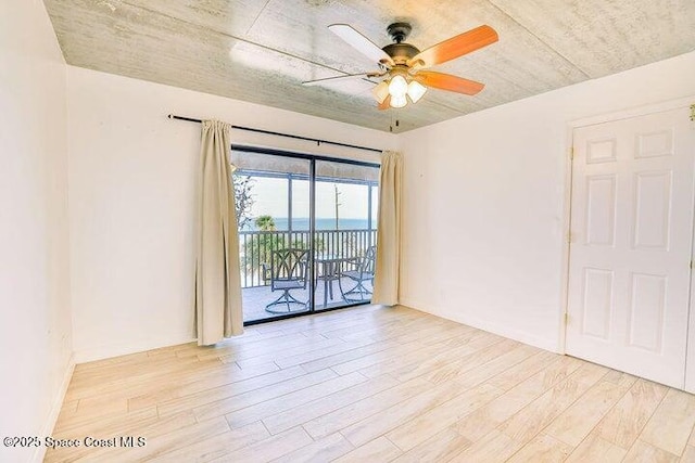 unfurnished room with a ceiling fan and wood finished floors