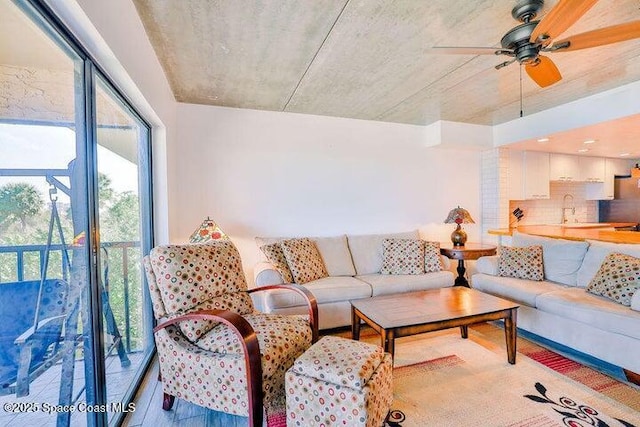 living area featuring a ceiling fan and wood finished floors