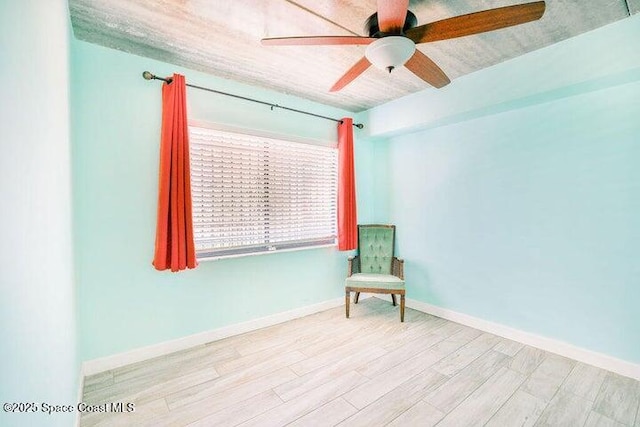unfurnished room featuring ceiling fan, baseboards, and wood finished floors