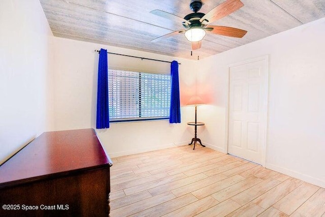 empty room with a ceiling fan and wood finished floors